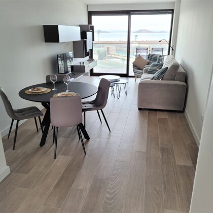 The living room with extendable table and TV with international channels